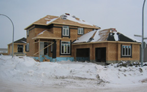An image of a home under construction in the winter